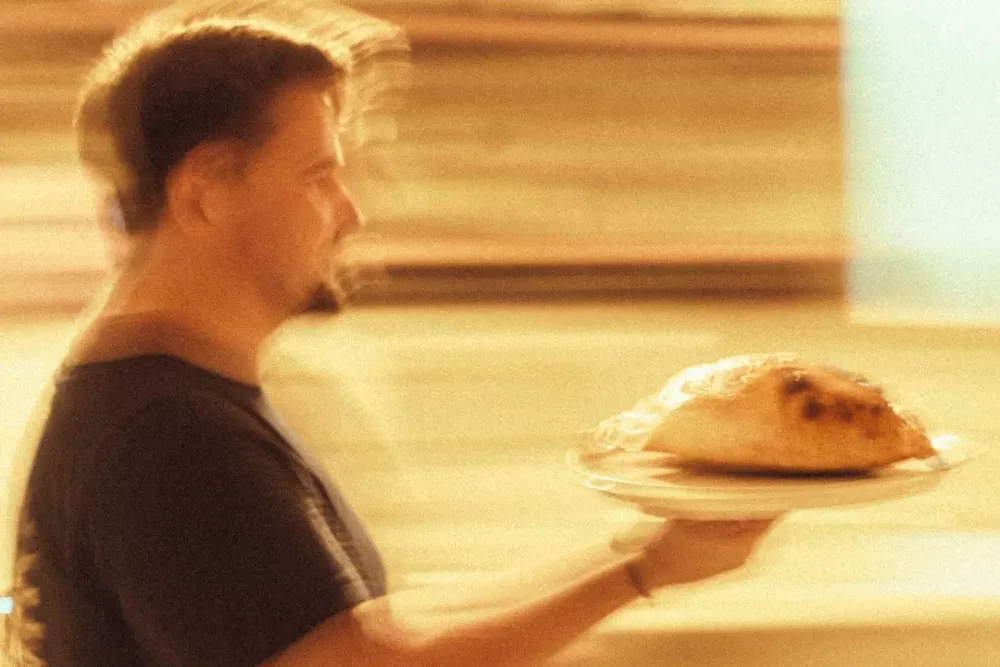 A freshly baked Calzone Dolce being carried from the Bandanna kitchen.